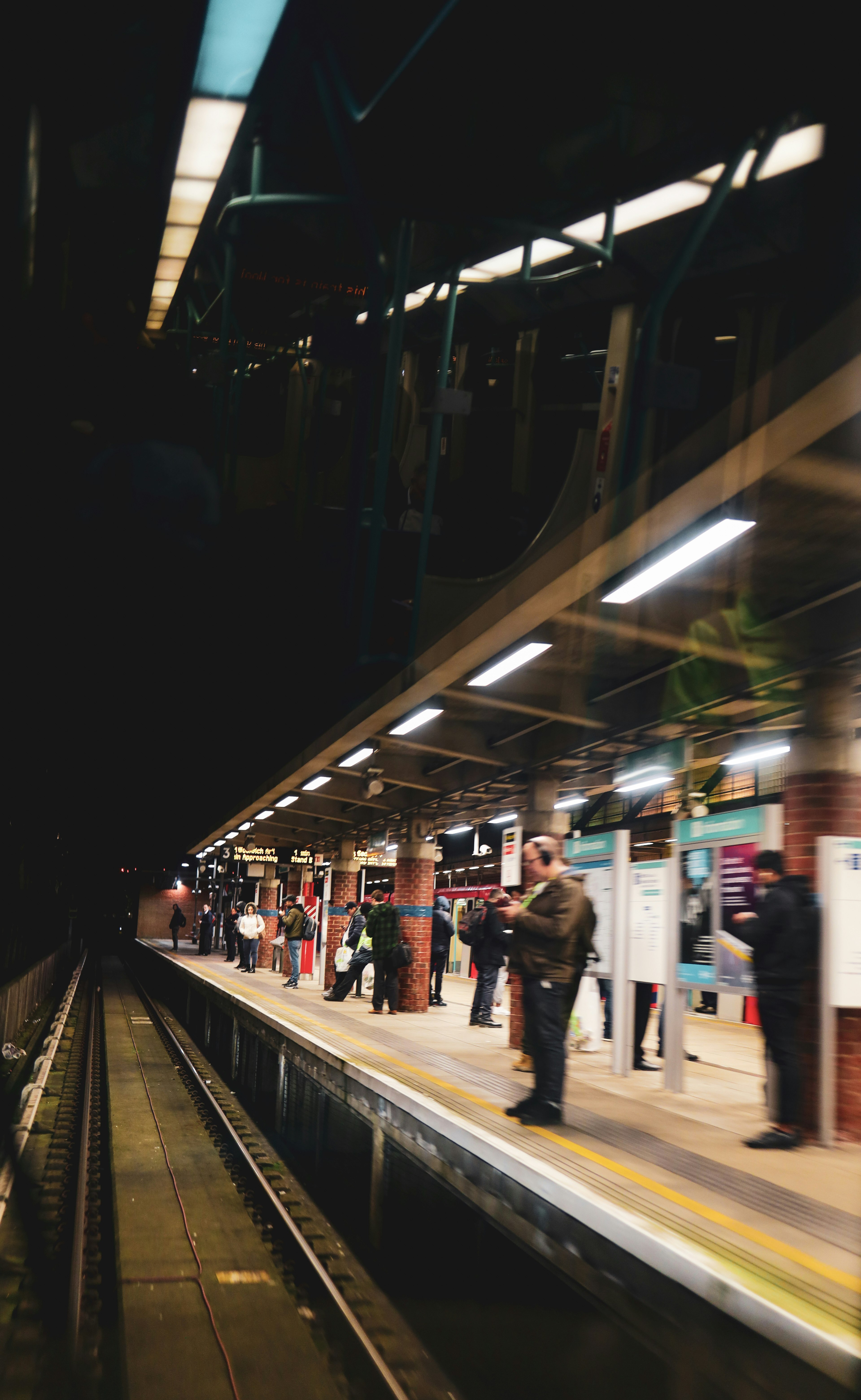 people walking on train station during night time