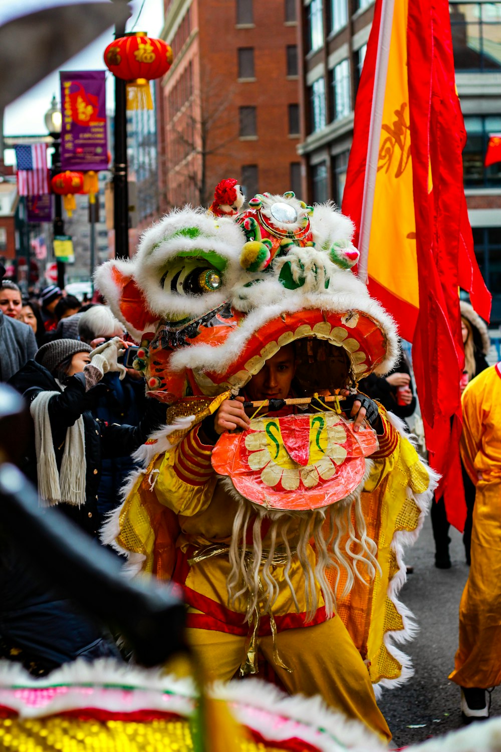 people in yellow and red traditional dress walking on street during daytime