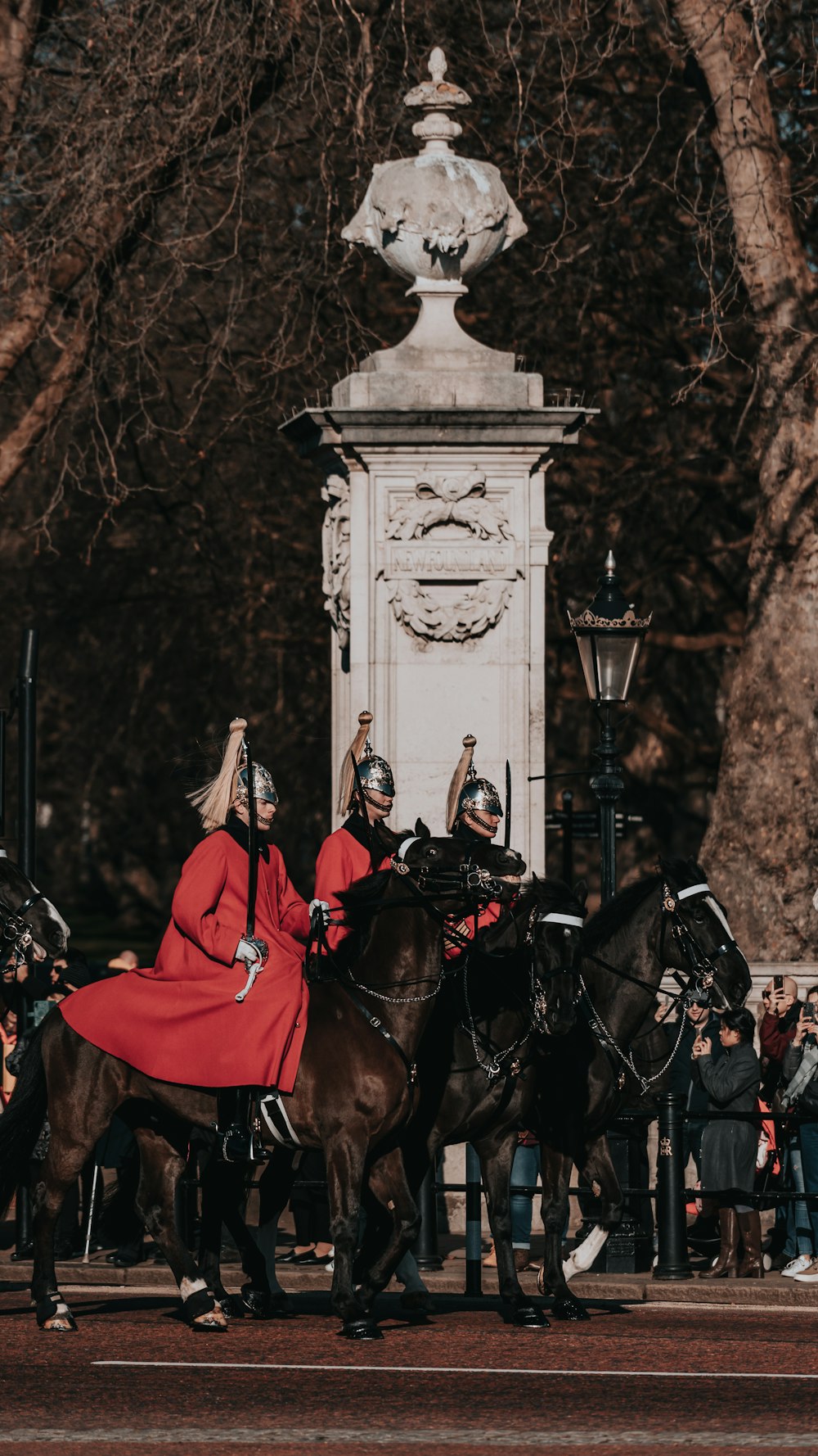 person in red coat riding horse