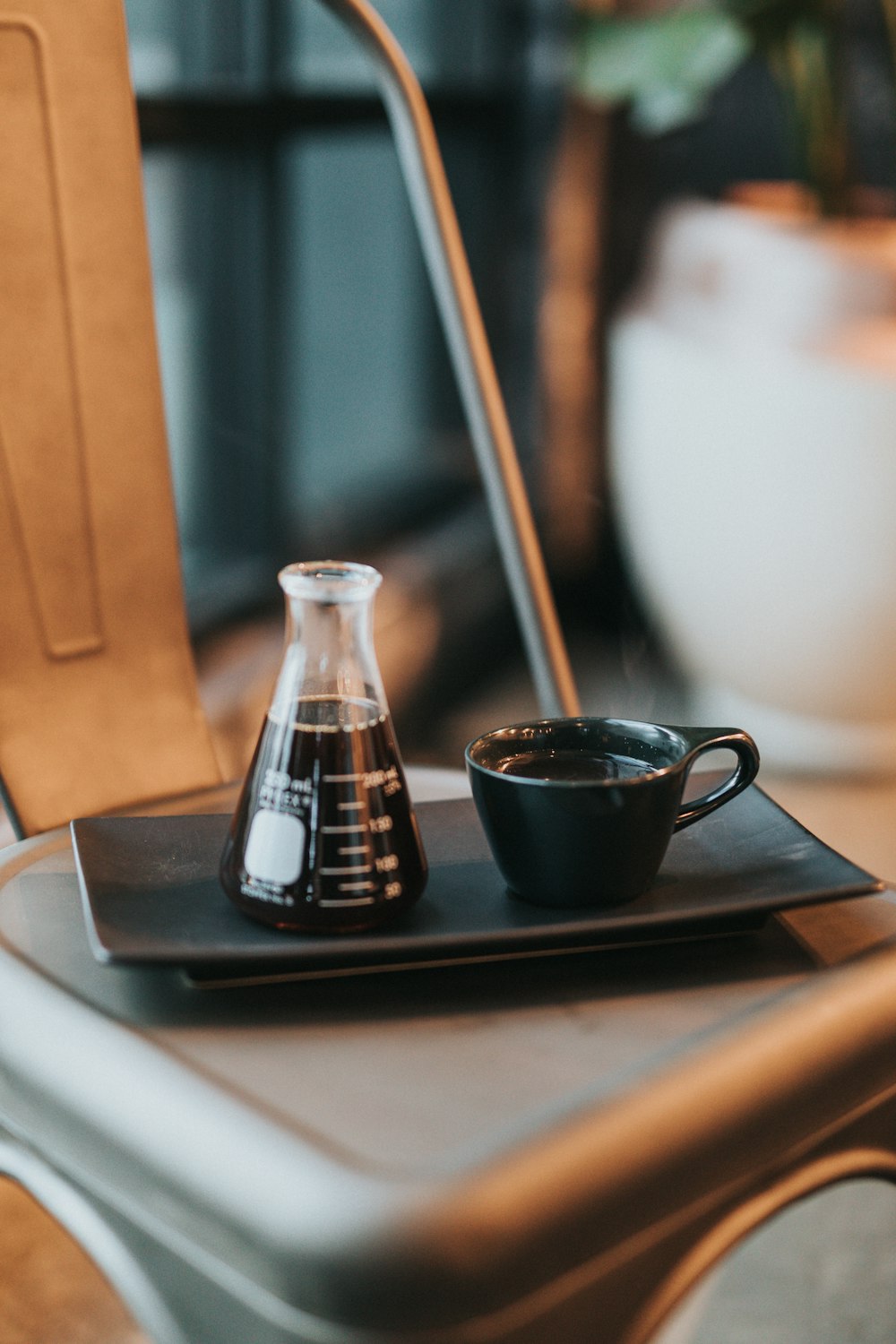 black ceramic mug on black laptop computer