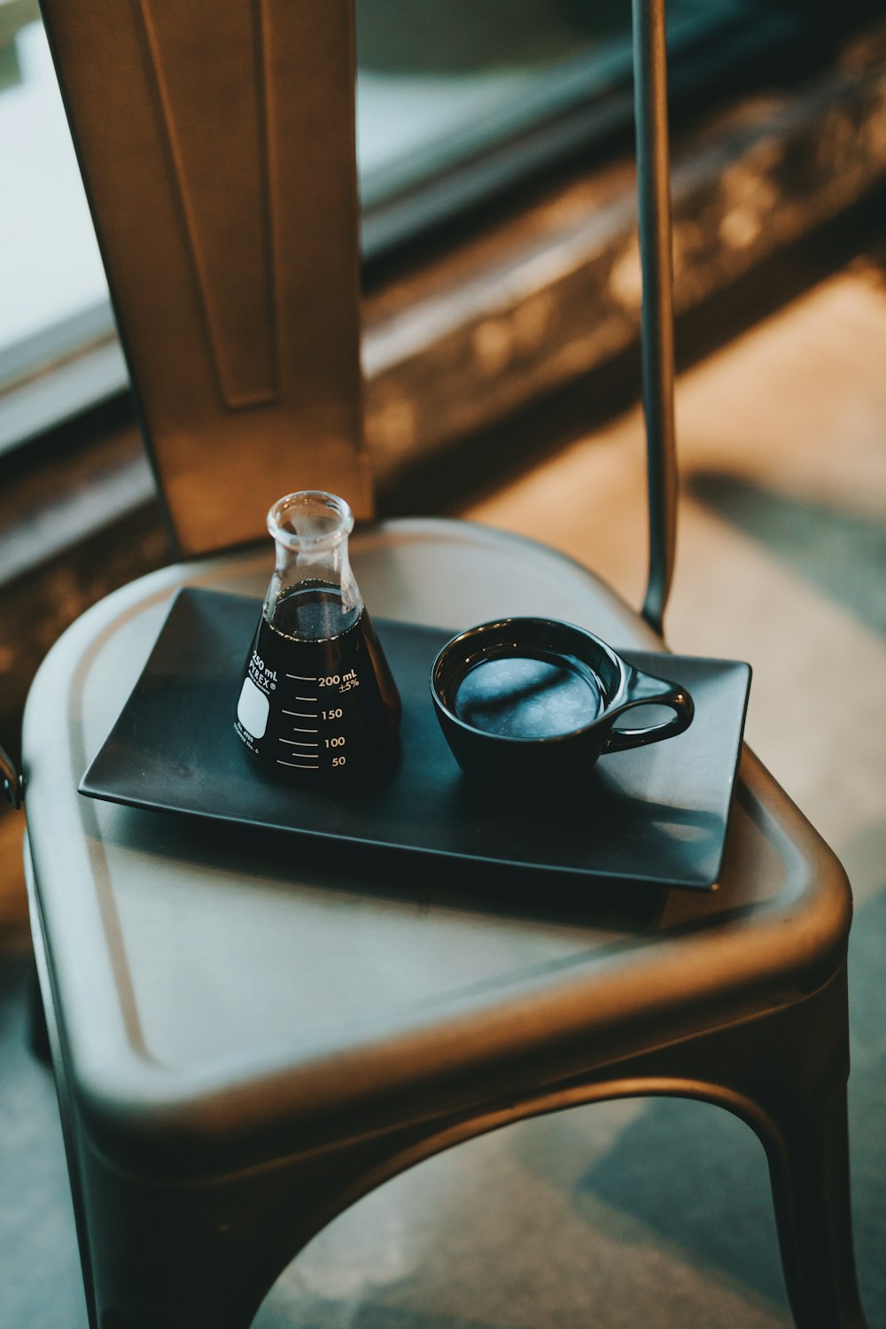 black framed eyeglasses on black tray