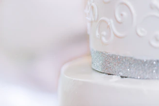 Close-up of a minimalist cake adorned with delicate gold accents and subtle textures.