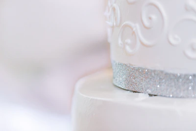 Close-up of a minimalist cake adorned with delicate gold accents and subtle textures.