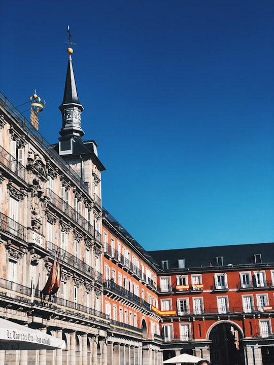 brown and white concrete building under blue sky during daytime in Plaza Mayor Spain