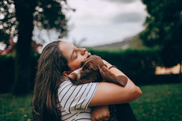 Woman hugging her mixed-breed dog