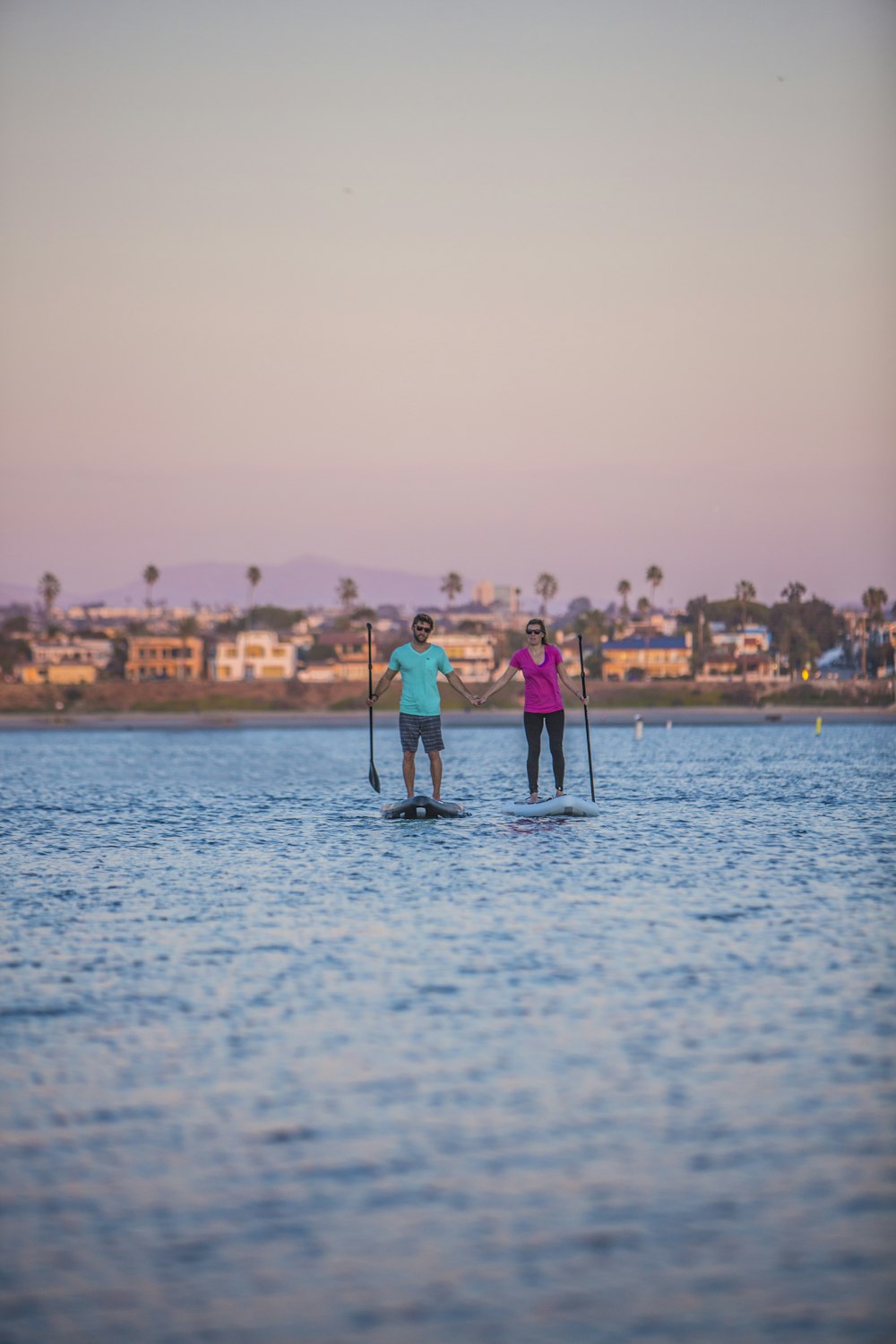 man and woman standing on sea shore during daytime