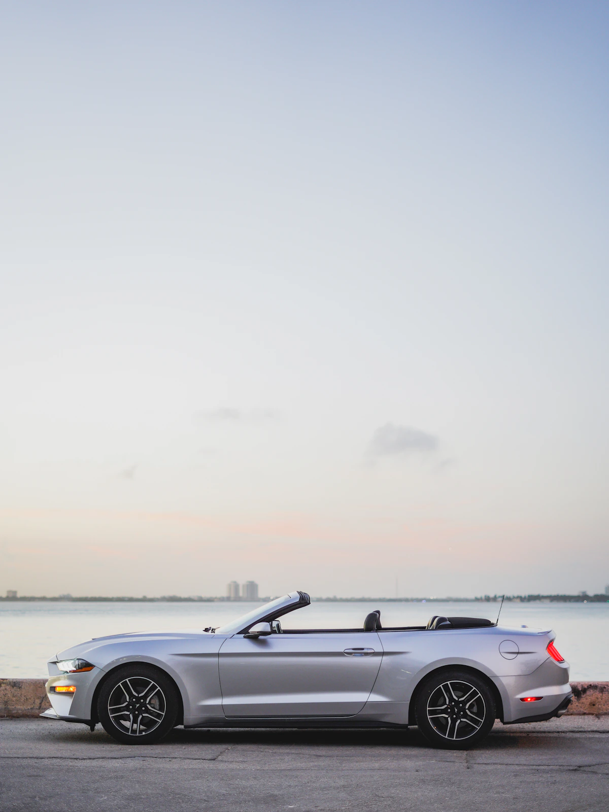 Classic convertible car with a freshly installed soft top parked outdoors