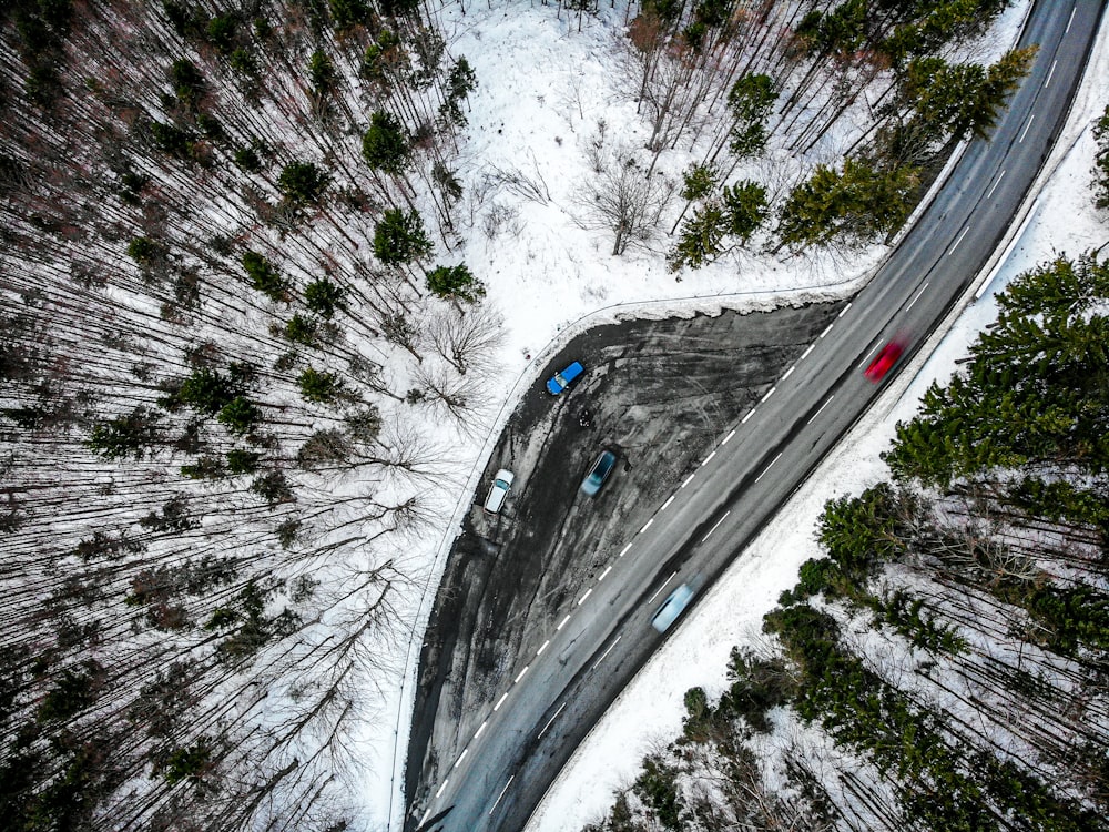 an aerial view of a road in the middle of a forest