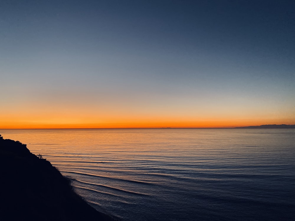 body of water during sunset