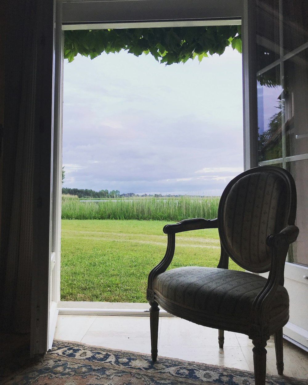 black and gray armchair beside glass window