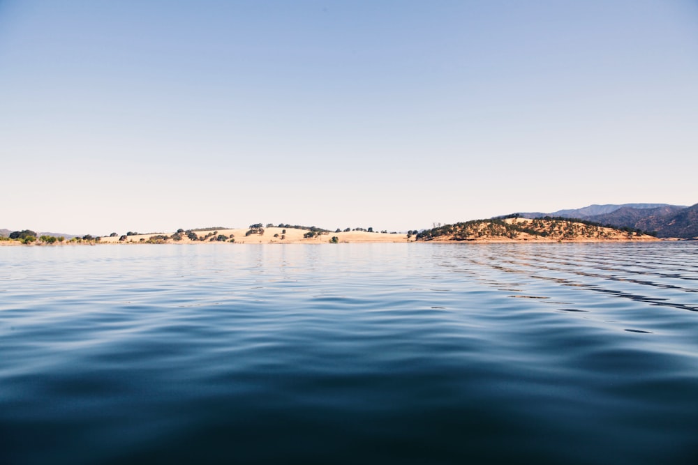 brown rock formation on sea water during daytime