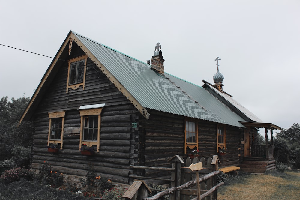 brown wooden house under gray sky