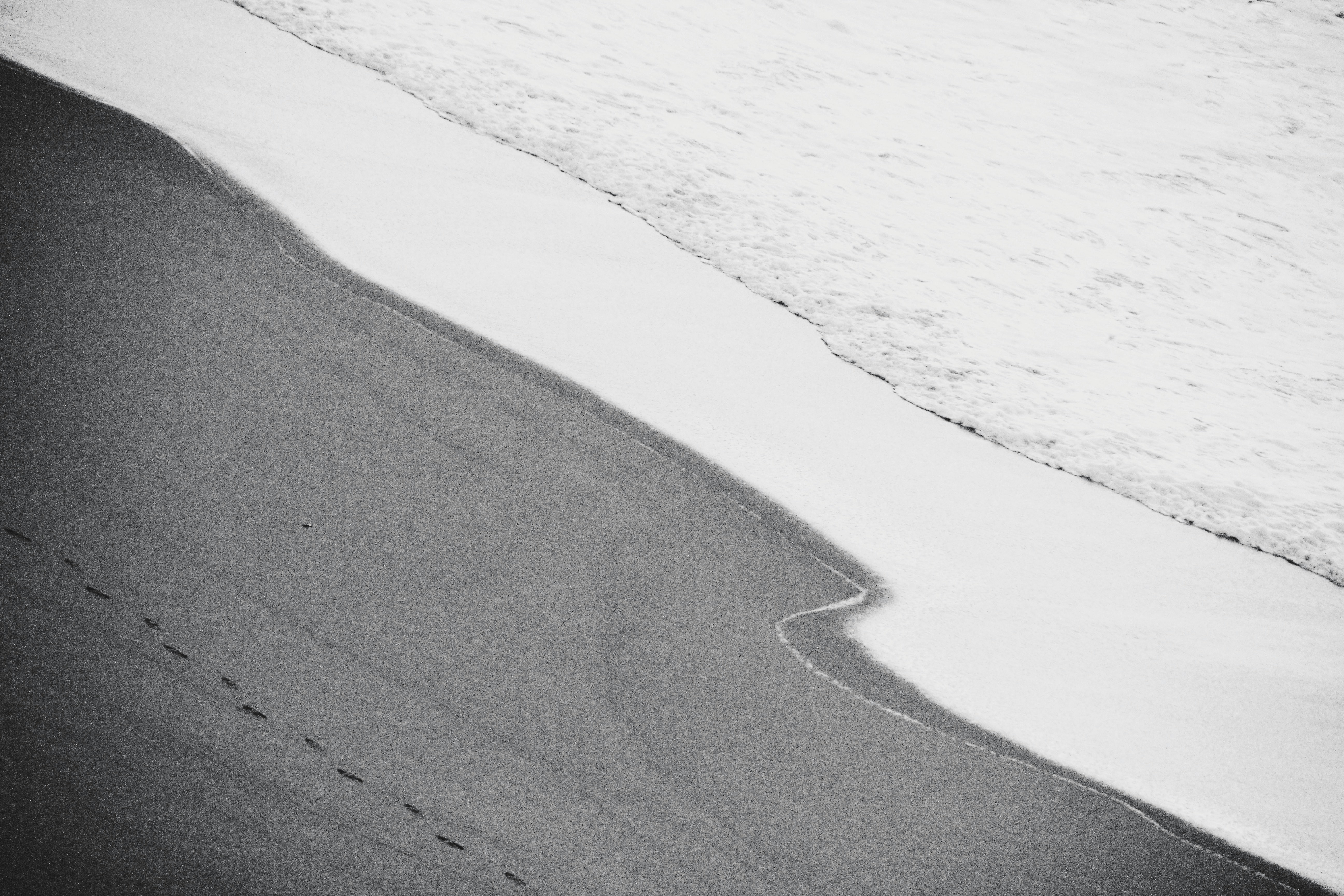 gray sand near body of water during daytime