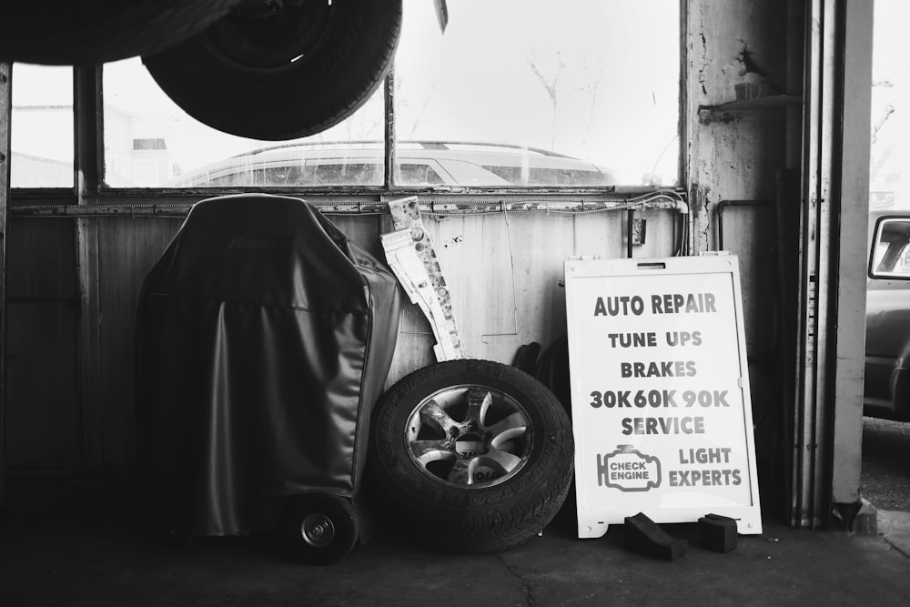 black wheel chair beside white wall