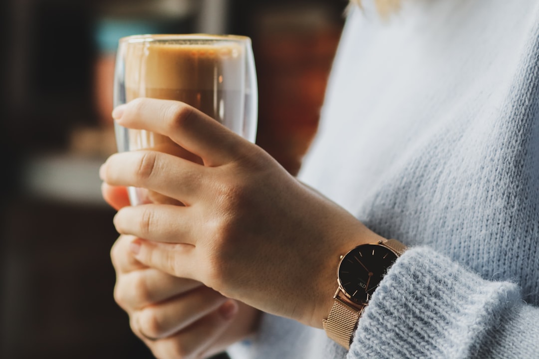 person holding clear drinking glass