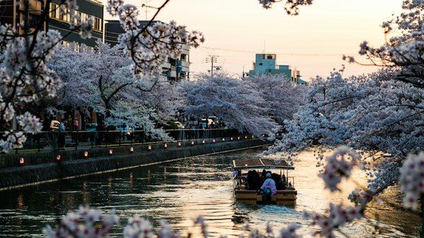 People riding on boat on river during daytime — Kyoto, Japan