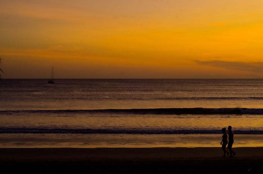 silhouette of boat on sea during sunset