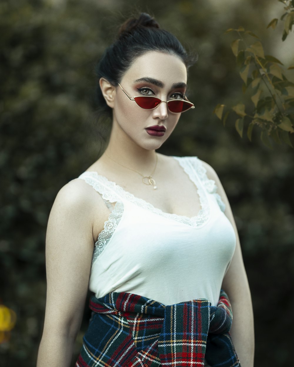 woman in white tank top wearing sunglasses