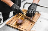 A chef preparing a delicious meat dish in a kitchen.