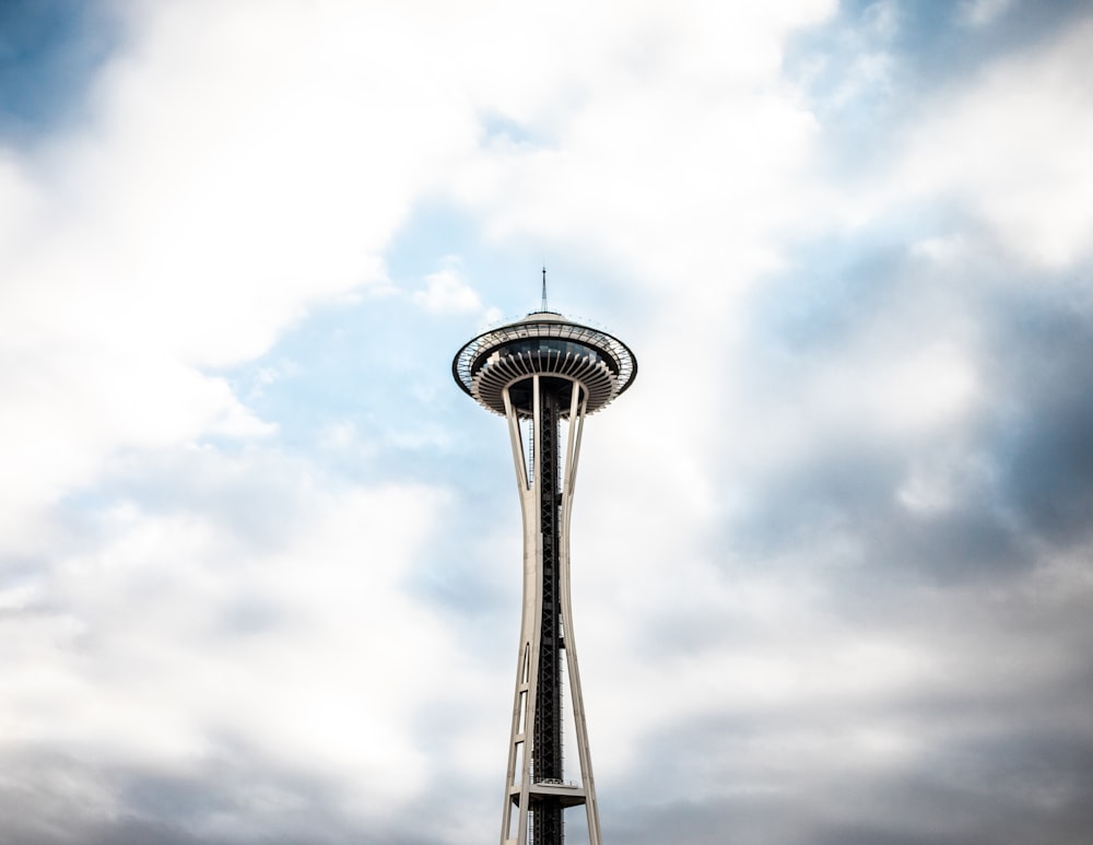 space needle tower under white clouds