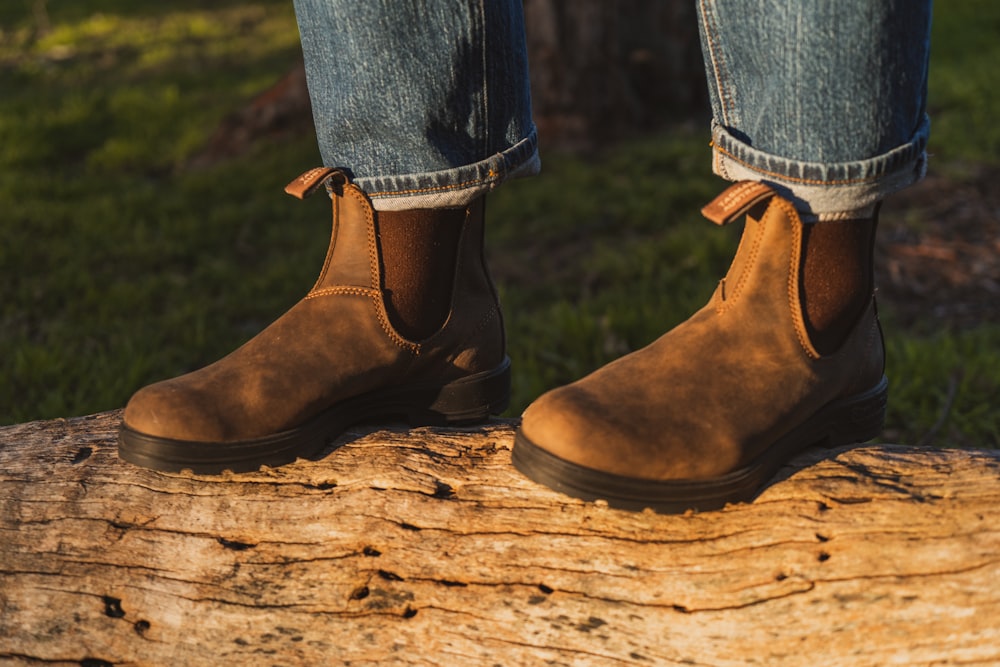 person wearing brown leather boots