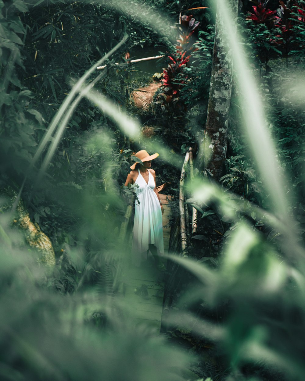 woman in white dress standing on green grass during daytime