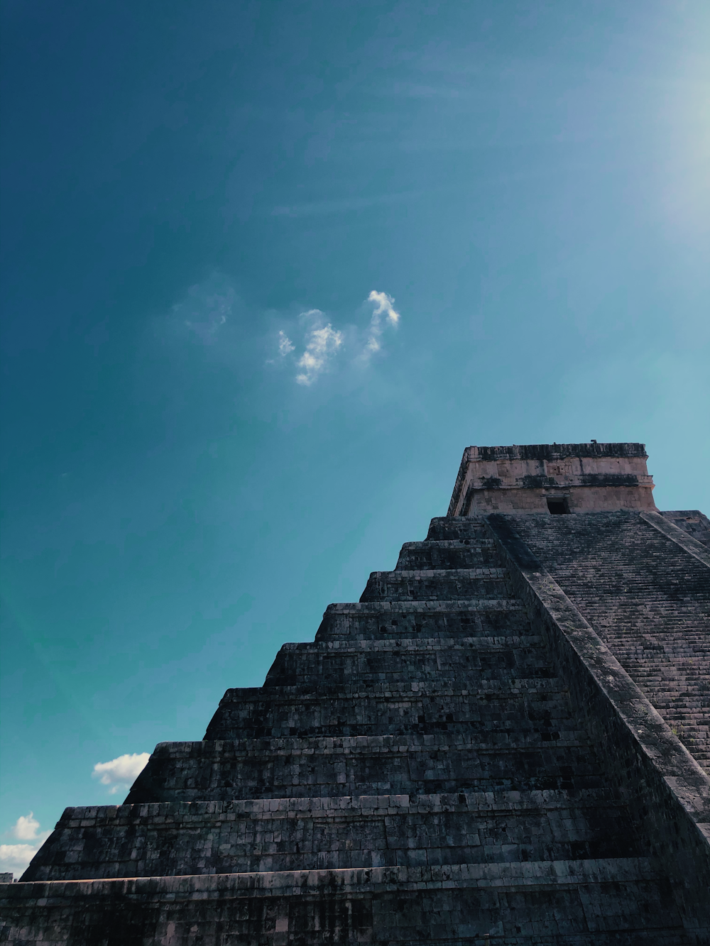 low angle photography of gray concrete building under blue sky during daytime