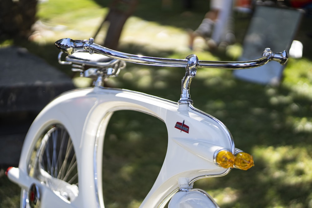 white and black motorcycle with gold chain