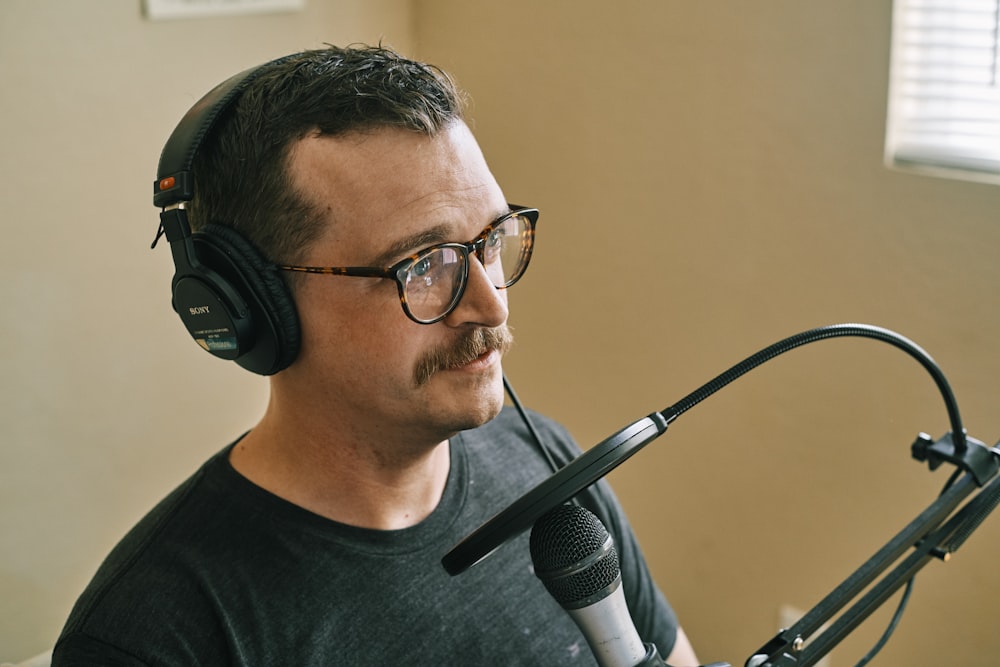 man in black crew neck shirt wearing black headphones