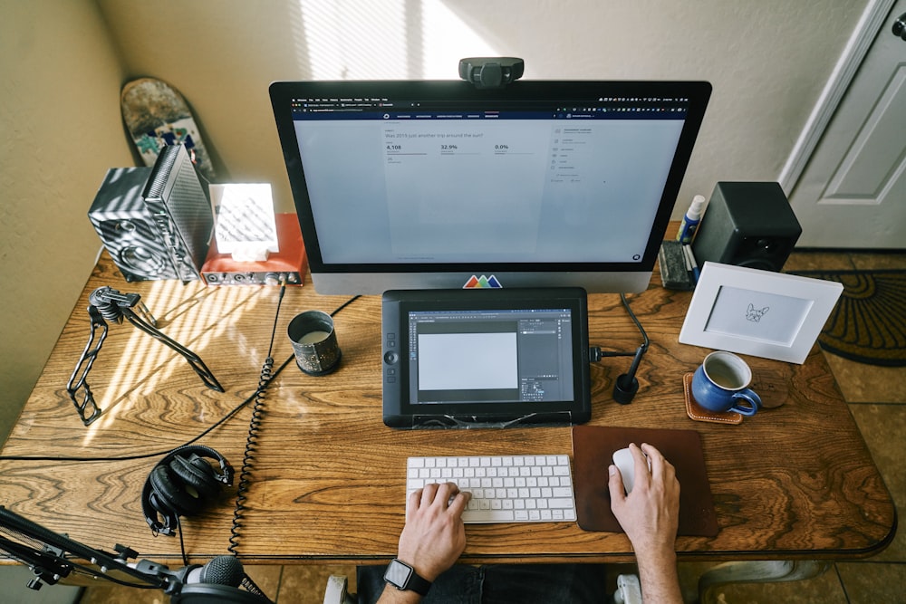 black flat screen computer monitor on brown wooden table