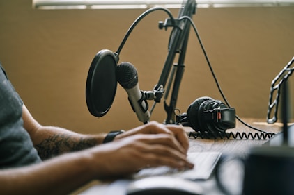 A close-up of a microphone and headphones symbolizing a podcast recording setup.