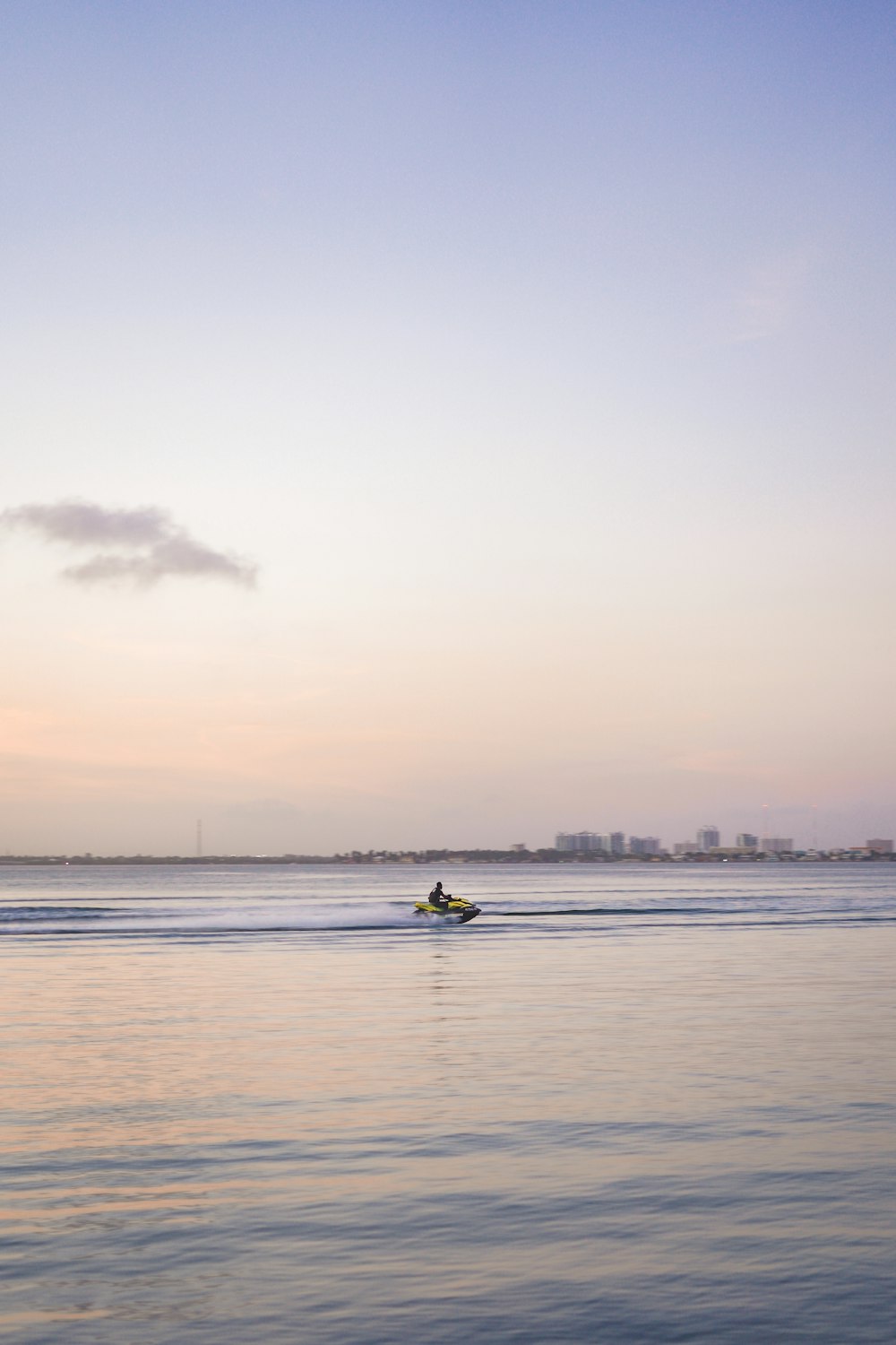 person riding on yellow kayak on sea during daytime