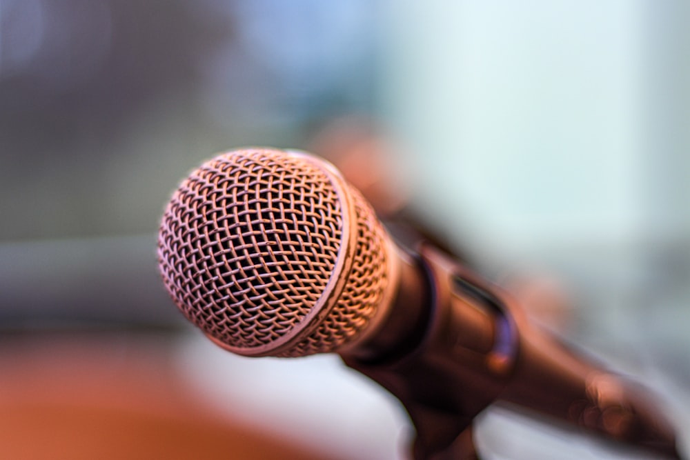 grey microphone on brown wooden stand