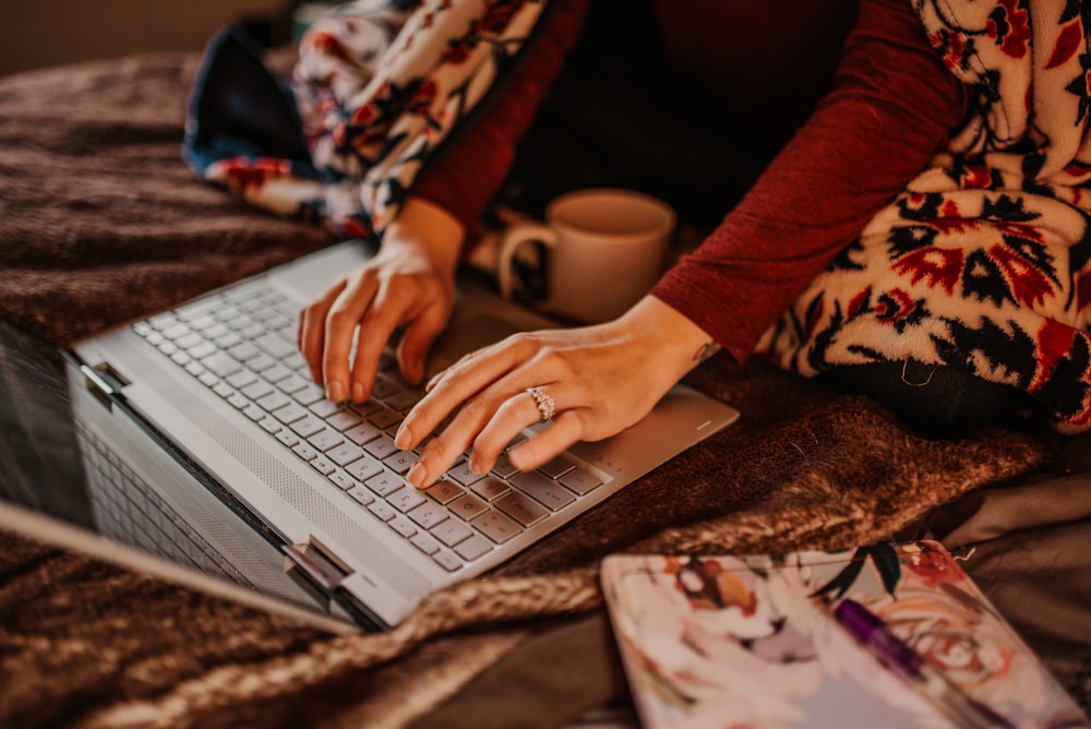 person using silver laptop computer