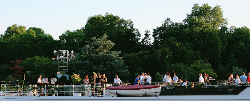 Friends gathered around a picnic setup on the boat, enjoying fresh snacks and smiles.