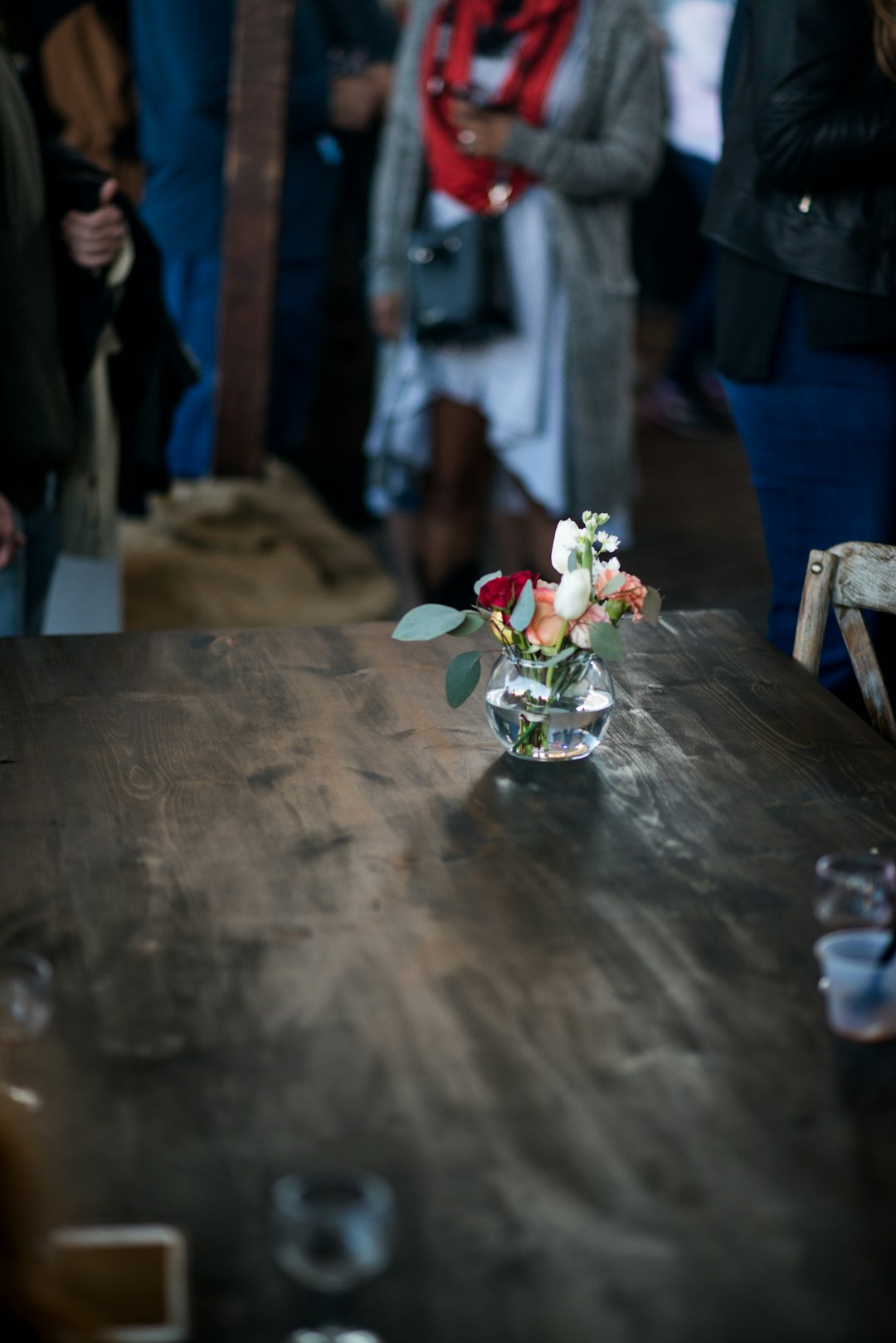 red and white flower bouquet on brown wooden table