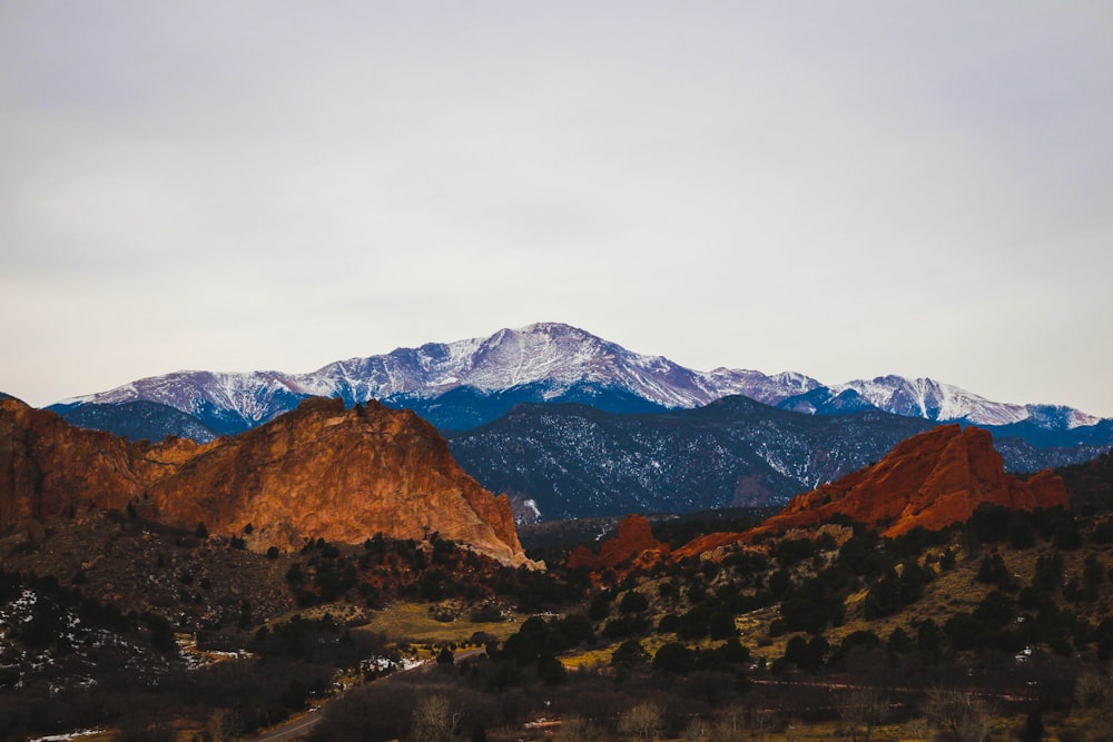 brown and green mountains under white sky during daytime