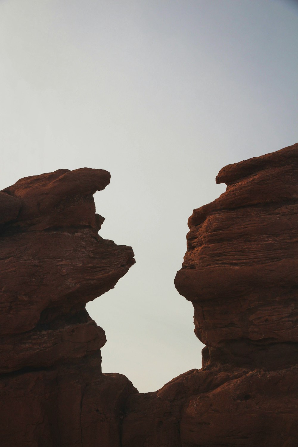 brown rock formation under white sky during daytime