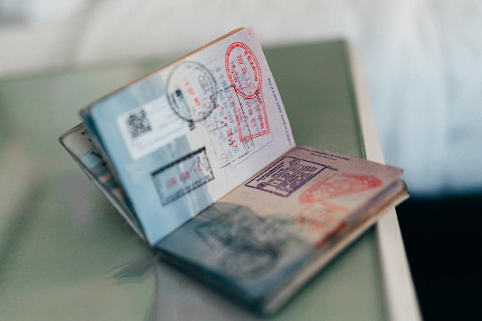 Open passport with multiple stamps and seals, illustrating the journey of obtaining a USAstudentvisa