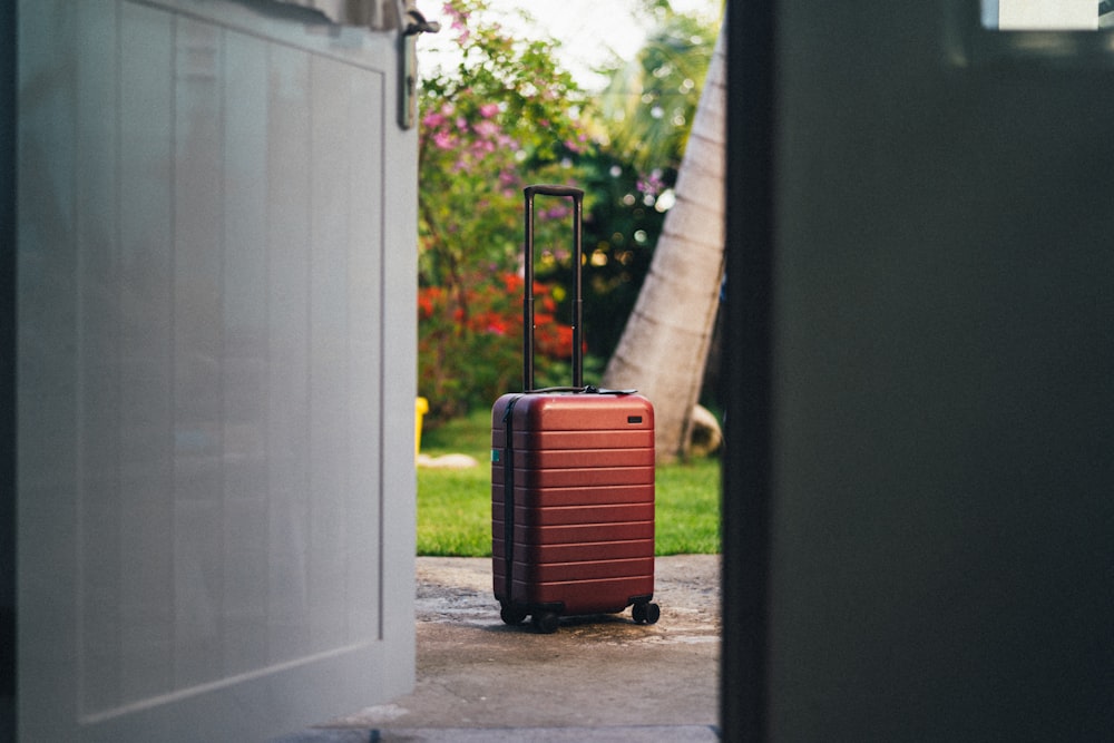 red and black luggage bag