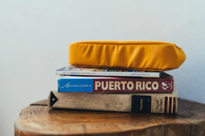 A stack of DIY guidebooks with craft supplies scattered around.