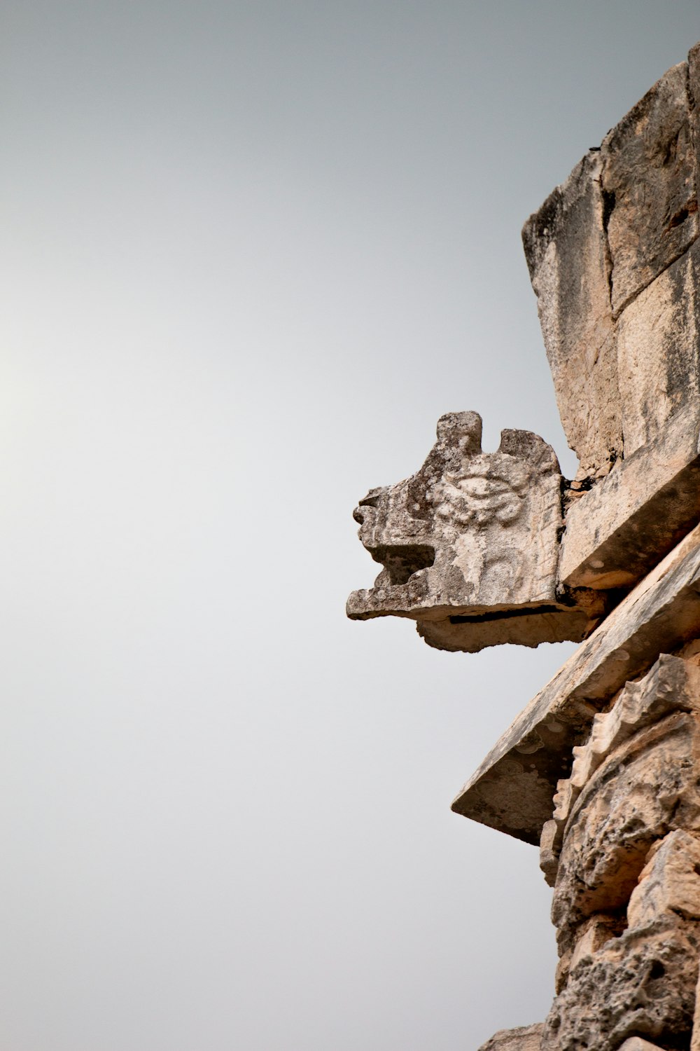 brown concrete wall with human face carved