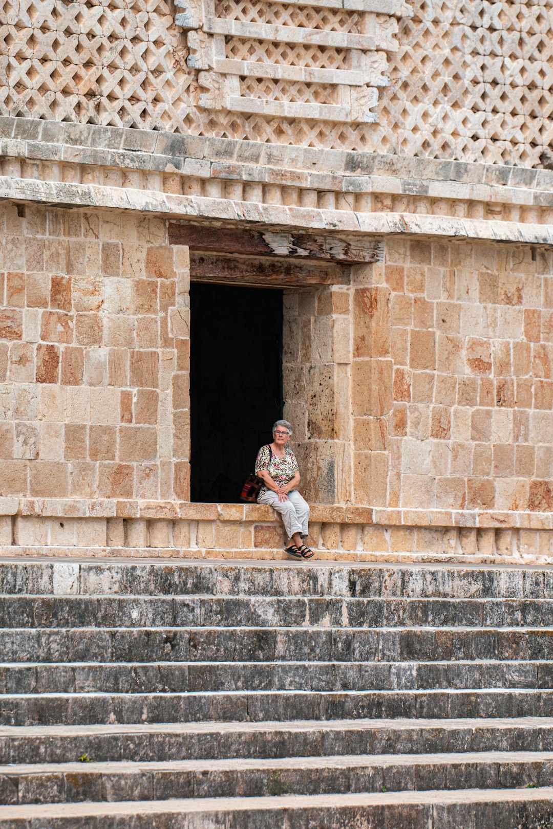 man in white long sleeve shirt sitting on concrete stairs