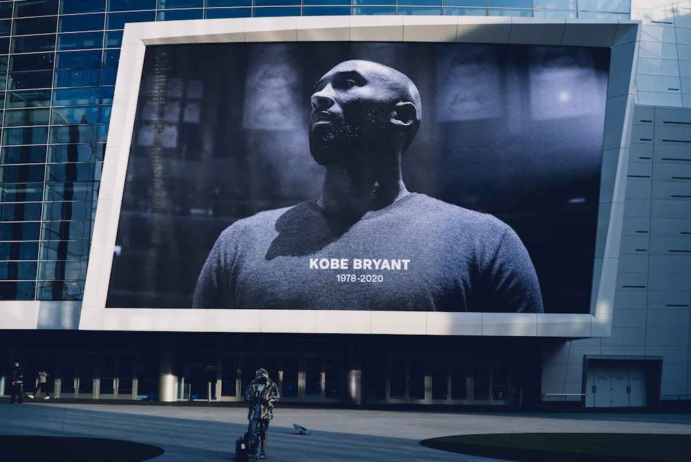 man in black crew neck shirt standing near black and white statue