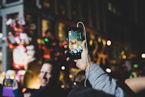 Listeners enjoying music on their smartphones in a lively Rafaela plaza