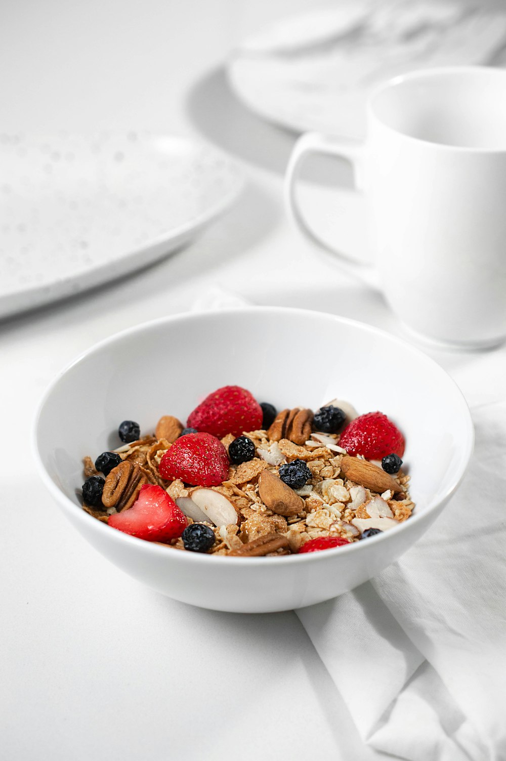 red and brown fruits on white ceramic bowl