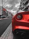 red car on the road during daytime