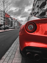 red car on the road during daytime