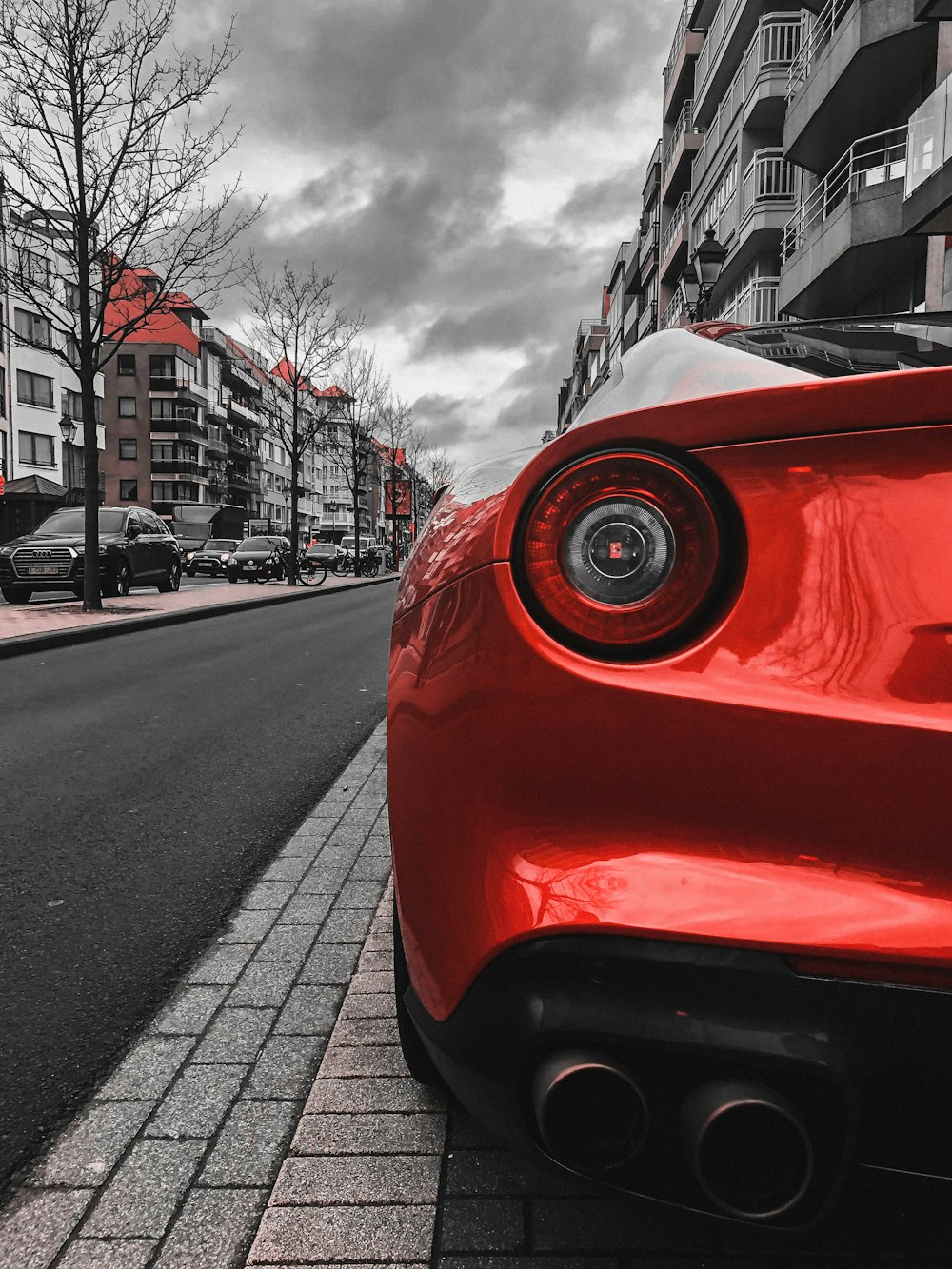 red car on the road during daytime