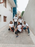A group of friends showcasing matching custom apparel outdoors.